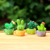 4pcs Mini Cactus Ornaments with Smiling Faces - Durable Plastic Tabletop Décor for Home, Office, Desk.